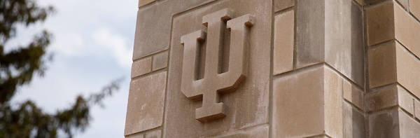 IU Trident logo on a limestone campus building